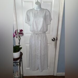 White dress with small black polka dots, also a belt